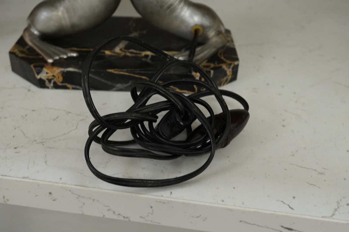 After Louis Carvin (French, 1875-1951) a twin seal lamp with circular frosted glass shade, 34cm high